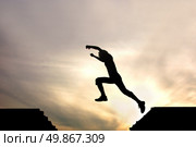 silhouette of jumping boy agains. Стоковое фото, агентство Ingram Publishing / Фотобанк Лори