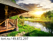 Wooden bathhouse near lake at the sunset. Стоковое фото, агентство Ingram Publishing / Фотобанк Лори