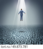 Powerful solutions with a businessman levitating above a maze or labyrinth as a business concept of leadership and conquering challenges and obstacles with a man rising above to find the answers. Стоковое фото, агентство Ingram Publishing / Фотобанк Лори