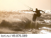 Kitesurfer jumping on a beautiful background of spray during the sunset. Стоковое фото, агентство Ingram Publishing / Фотобанк Лори