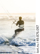 Kitesurfer in action on a beautiful background of spray during the sunset. Стоковое фото, агентство Ingram Publishing / Фотобанк Лори