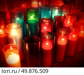 Spiritual candles as a candlelight memorial in a religious ceremony as a commemorative tradition in religion to celebrate the life of loved ones with church prayers of hope and respect. Стоковое фото, агентство Ingram Publishing / Фотобанк Лори