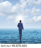 Walk on water with a businessman walking on the surface of an ocean as a business concept of confidence and courage to take on an impossible challenge and achieve success with the power of belief. Стоковое фото, агентство Ingram Publishing / Фотобанк Лори