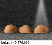 Shell game with three walnut shells on city street pavement with a light shinning on the winning choice as a business concept of choosing the right investment with the assistance of professional guidance. Стоковое фото, агентство Ingram Publishing / Фотобанк Лори