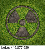 Contaminated soil concept with a green grass and the radio active symbol embosed in the ground exposing the poisoned earth as an icon of environmental disaster after a nuclear disaster and the dangerous fallout that lingers on. Стоковое фото, агентство Ingram Publishing / Фотобанк Лори