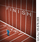 Upward climb business idea to overcome adversity with a businessman standing at the start line of a track and field path facing an obstacle to achieving a planned strategy for success and to go to the finish. Стоковое фото, агентство Ingram Publishing / Фотобанк Лори