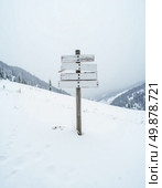 A weathered signpost stands alone against a blanket of white snow, guiding adventurers toward Snow Mountain North, set in a remote, tranquil wilderness during wintertime Generative AI. Стоковое AI-изображение, AI-художник Юлия Петровская / Фотобанк Лори