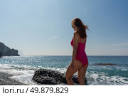 Beach Ocean Woman Summer sunbather in pink swimsuit walks on sunny beach for relaxation. Стоковое фото, фотограф svetograph / Фотобанк Лори