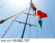 Flags of different countries on the mast of sailboat. Стоковое фото, агентство Ingram Publishing / Фотобанк Лори