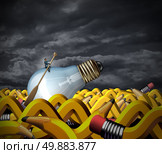 Creative problem solving and business management concept as a businessman sitting on a lightbulb with a boat paddle navigating on an ocean made of pencils shaped as waves as a symbol of goal strategy and vision persistence. Стоковое фото, агентство Ingram Publishing / Фотобанк Лори