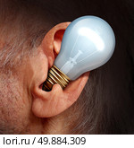Listen to ideas concept as a lightbulb inside a human ear as a symbol of listening and tuning in to creative thoughts and hearing success advice. Стоковое фото, агентство Ingram Publishing / Фотобанк Лори
