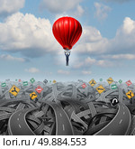 Easy way forward rise above confusion leadership concept with a businessman in a balloon flying and soaring over a complicated group of roads as a business metaphor of innovative creative thinking for success. Стоковое фото, агентство Ingram Publishing / Фотобанк Лори