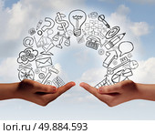 Business exchange concept as two human hands from diverse cultural backgrounds exchanging financial and economic information and training as a metaphor for team success. Стоковое фото, агентство Ingram Publishing / Фотобанк Лори