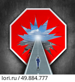Business breakthrough and overcoming road blocks as a red and white stop sign with a hole revealing a path for a person to walk towards career or life success. Стоковое фото, агентство Ingram Publishing / Фотобанк Лори