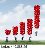 Business success graph as a group of businesspeople holding balloons shaped as a financial chart with one individual businessman with enough balloon objects accumulated to reach critical mass to rise above and succeed. Стоковое фото, агентство Ingram Publishing / Фотобанк Лори