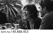 Several individuals gathered at a table, sharing laughter and enjoyment in each others company. Стоковое AI-изображение, AI-художник Данила Большаков / Фотобанк Лори