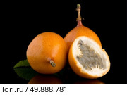 Passion fruit maracuja granadilla on black background. Стоковое фото, агентство Ingram Publishing / Фотобанк Лори