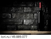 Brick wall in cellar and bottle of cabernet. Стоковое фото, агентство Ingram Publishing / Фотобанк Лори