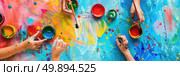 A group of individuals are actively painting colorful designs on a large wall in an urban setting, each person focused on their creative task. Стоковое AI-изображение, AI-художник Данила Большаков / Фотобанк Лори