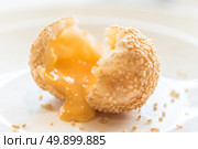 Chinese dim sum Fried sesame balls stuff with custard lava - Chinese groumet cuisine. Стоковое фото, агентство Ingram Publishing / Фотобанк Лори