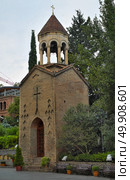 Old bell tower of Sioni Cathedral, Tbilisi (Georgia), terracotta brick architecture with stone arches and crosses, surrounded by lush greenery. Стоковое фото, фотограф Елена  Попкова / Фотобанк Лори