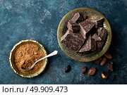 Dark chocolate pieces crushed and cocoa beans, culinary background, directly above. Стоковое фото, агентство Ingram Publishing / Фотобанк Лори