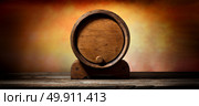 Wooden cask for liquid on old timber table . Стоковое фото, агентство Ingram Publishing / Фотобанк Лори