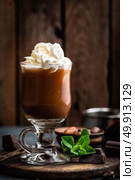 Iced cocoa drink with whipped cream, cold chocolate beverage, coffee frappe on dark background. Стоковое фото, агентство Ingram Publishing / Фотобанк Лори