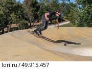 Skateboarder practice on a pump track park on a sunny summer day. Стоковое фото, агентство Ingram Publishing / Фотобанк Лори