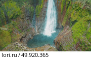 Waterfall Catarata Del Toro plunging into bright blue pool in rainforest of Costa Rica. Стоковое видео, видеограф Igor Tichonow / Фотобанк Лори