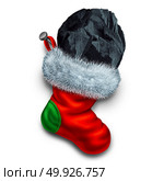 Chunk of coal in holiday stocking as a christmas symbol for naughty children gift or bad people seasonal winter present representing a punishment for bad behavior. Стоковое фото, агентство Ingram Publishing / Фотобанк Лори