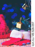 Red hat and socks for Christmas gift. Стоковое фото, агентство Ingram Publishing / Фотобанк Лори