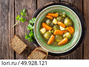 Vegetable soup with brussel sprouts on wooden rustic table, top view. Стоковое фото, агентство Ingram Publishing / Фотобанк Лори