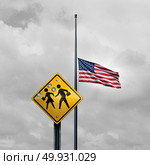 School shooting tragedy and horrific gunfire towards students as a sign with bullet holes with an american flag at half mast for a tragic violent event in the United States with 3D illustration elements. Стоковое фото, агентство Ingram Publishing / Фотобанк Лори