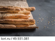 Bread sticks with salt and herbs on dark board. Стоковое фото, агентство Ingram Publishing / Фотобанк Лори