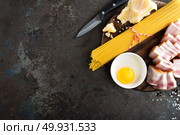 Ingredients for cooking Carbonara pasta, spaghetti with pancetta, egg and hard parmesan cheese. Traditional italian cuisine. Pasta alla carbonara. Стоковое фото, агентство Ingram Publishing / Фотобанк Лори