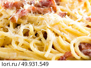 Carbonara pasta, spaghetti with pancetta, egg, hard parmesan cheese and cream sauce. Traditional italian cuisine. Pasta alla carbonara isolated, background. Стоковое фото, агентство Ingram Publishing / Фотобанк Лори