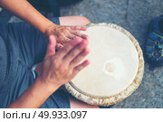 People hands playing music at djembe drums, vintage filter image. Стоковое фото, агентство Ingram Publishing / Фотобанк Лори