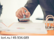 Business hand putting stamp on a document, close up. Стоковое фото, агентство Ingram Publishing / Фотобанк Лори