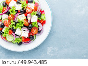 Greek salad of fresh cucumber, tomato, sweet pepper, lettuce, red onion, feta cheese and olives with olive oil. Стоковое фото, агентство Ingram Publishing / Фотобанк Лори