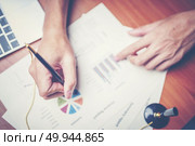 Business hands pointing and signing terms and agreement papers contract, signing concept. Стоковое фото, агентство Ingram Publishing / Фотобанк Лори