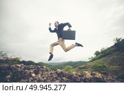 Cheerful Business Man Jumping and Shouting, Successful Corporate People Yelling and Celebrating Joy of Success on Mountain Peak. Стоковое фото, агентство Ingram Publishing / Фотобанк Лори