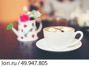 Cup of cappuccino at coffee shop background. . Стоковое фото, агентство Ingram Publishing / Фотобанк Лори