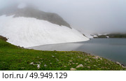 Glacial lake in low clouds in foggy changeable weather. Стоковое фото, фотограф Саблин Станислав / Фотобанк Лори