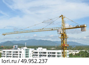 Crane and building working progress. Crane and building working progress, construction site. Стоковое фото, агентство Ingram Publishing / Фотобанк Лори