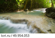 Deep forest waterfall at Erawan waterfall National Park Kanjanaburi Thailand. Стоковое фото, агентство Ingram Publishing / Фотобанк Лори