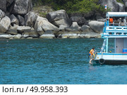 Phuket, THAILAND - JANUARY 4, 2017. A tourist wearing a bikini swim in the sea in Phuket. Редакционное фото, агентство Ingram Publishing / Фотобанк Лори