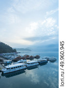 Nantou, Taiwan - November 02, 2016 : Tourist boats docking in peachful morning at Shuishe Pier, Sun Moon Lake, Taiwan. Редакционное фото, агентство Ingram Publishing / Фотобанк Лори