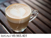 Close up of cappuccino cup with heart shaped milk pattern at caf. Close up of cappuccino cup with heart shaped milk pattern at cafe. a cup of coffee art. Стоковое фото, агентство Ingram Publishing / Фотобанк Лори