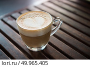 Close up of cappuccino cup with heart shaped milk pattern at caf. Close up of cappuccino cup with heart shaped milk pattern at cafe. a cup of coffee art. Стоковое фото, агентство Ingram Publishing / Фотобанк Лори